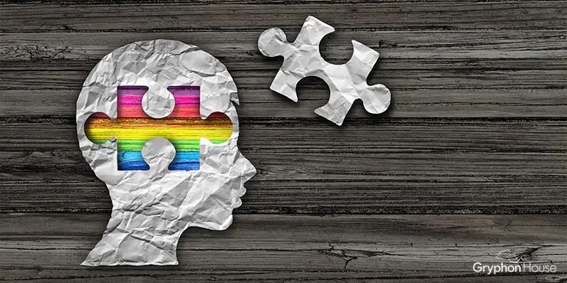 Illustration of a child's head with a puzzle piece removed revealing a rainbow pattern underneath