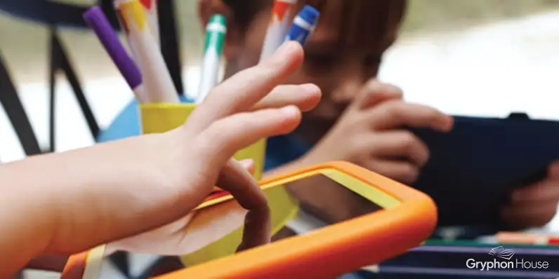 Young children using tablet computers in a classroom