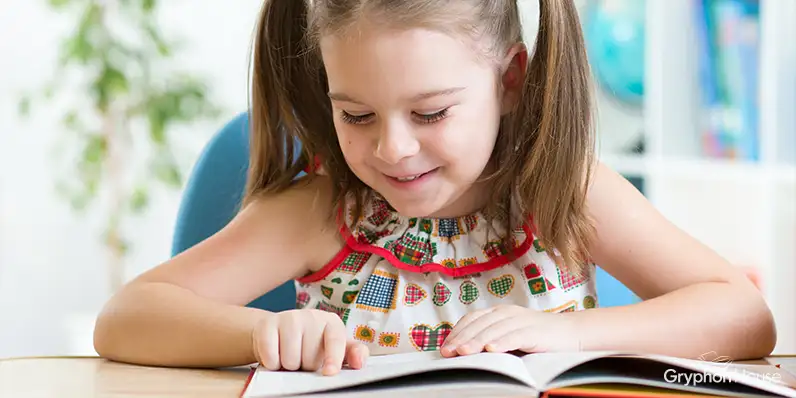 Young girl reading a picture book