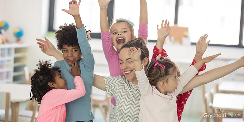 Children jumping and dancing with their arms up